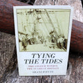 A book cover of 'Tying the Tides: The Colour within the SS Great Britain' featuring an old photograph of people onboard a ship, with the title and author name displayed.
